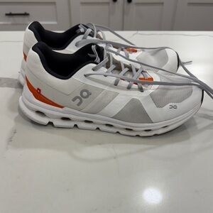 On Running White and Orange Athletic Shoes